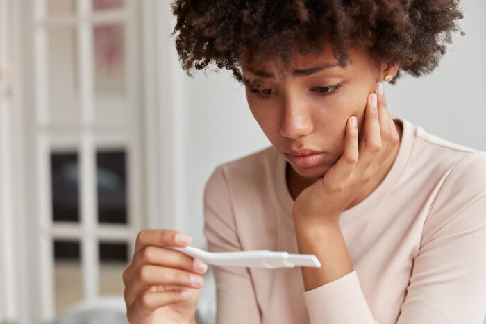 Worried woman checking pregnancy test family secrets
