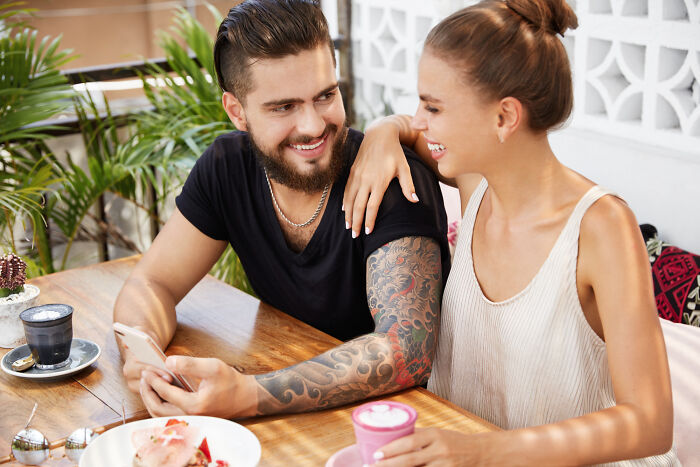 Smiling couple enjoying coffee together showing relationship connection