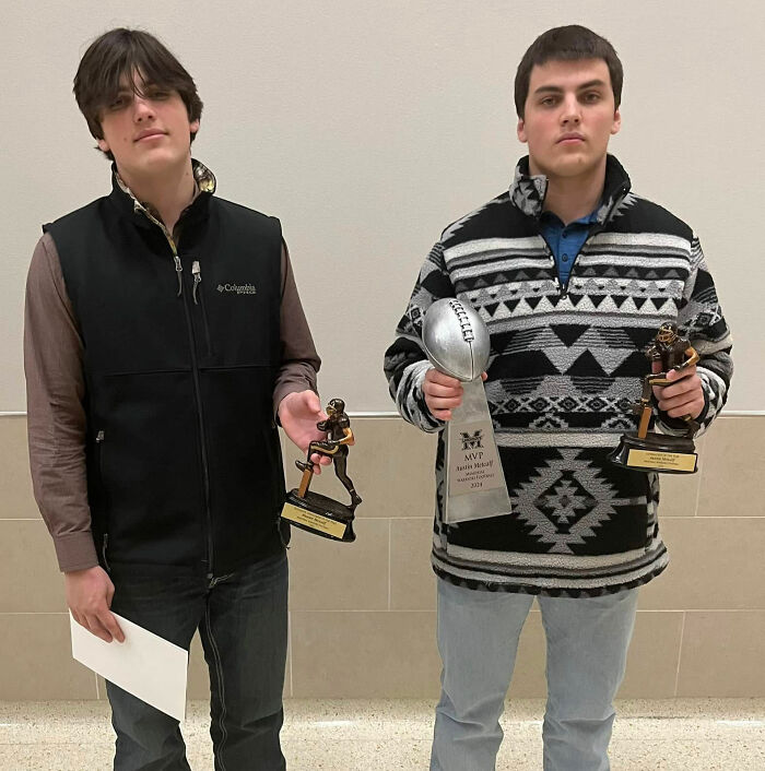 Two young men holding football trophies connected to Karmelo Anthony's sentence coverage