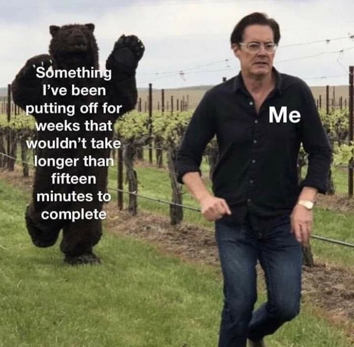 A relatable meme featuring a man running from a bear costume, labeled 'Me' and 'Something I've been putting off.'