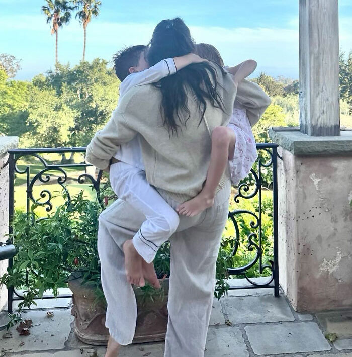 Meghan Markle's Father's Day photo featuring a woman embracing two children, sparking parenting concerns. Meghan Markle's Father's Day photo featuring a woman embracing two children, sparking parenting concerns.