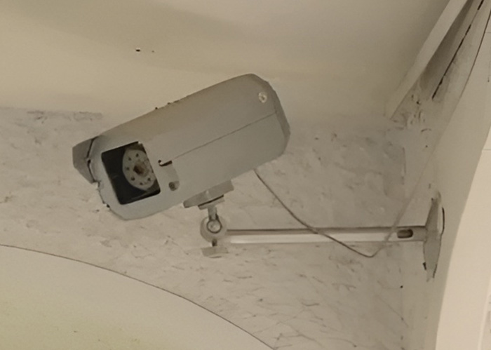Security camera on wall monitoring area in home