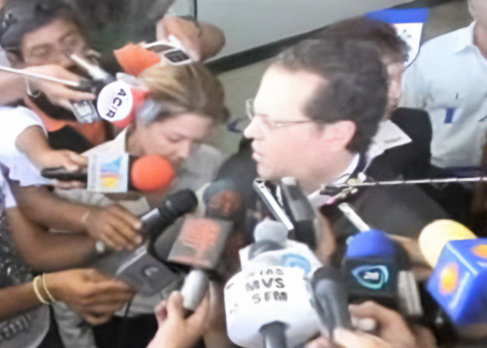 Reporters crowd around a man during press coverage of a vanished 4-year-old girl case