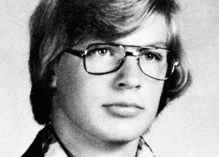 Black and white vintage portrait of a young man wearing glasses