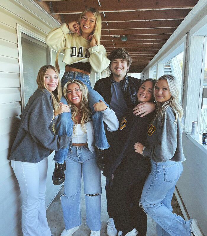 Group photo of young adults smiling on porch related to Bryan Kohberger victims