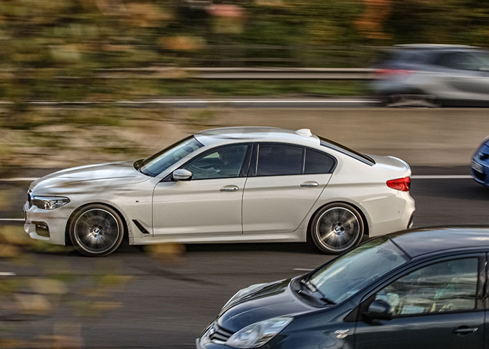 White car speeding on highway illustrating traffic-related life mistakes