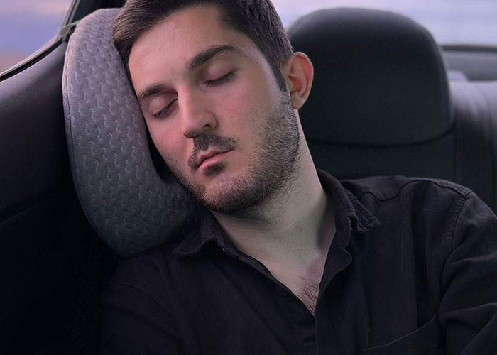 Man sleeping in car seat illustrating legal offense