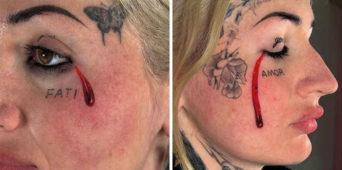 Close-up of face tattoo with realistic red teardrop and faded lettering near eye