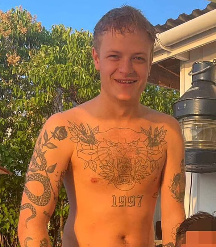Young man with tattoos smiling outdoors, related to Norway trial update