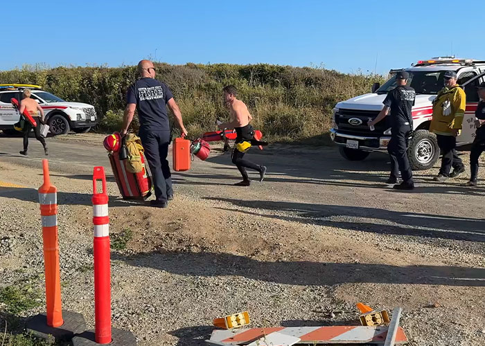 Rescue team preparing for emergency at California beach scene Rescue team preparing for emergency at California beach scene