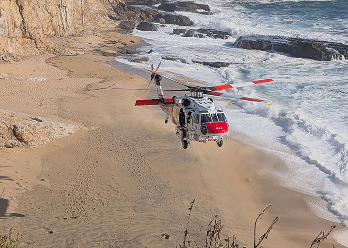 Coast Guard helicopter flying over California beach rescue area Coast Guard helicopter flying over California beach rescue area