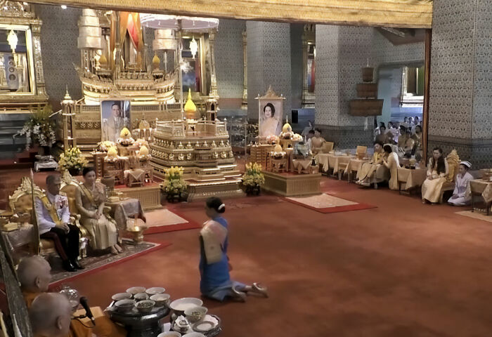 Thai princess funeral ceremony in ornate royal setting with people in traditional attire Thai princess funeral ceremony in ornate royal setting with people in traditional attire