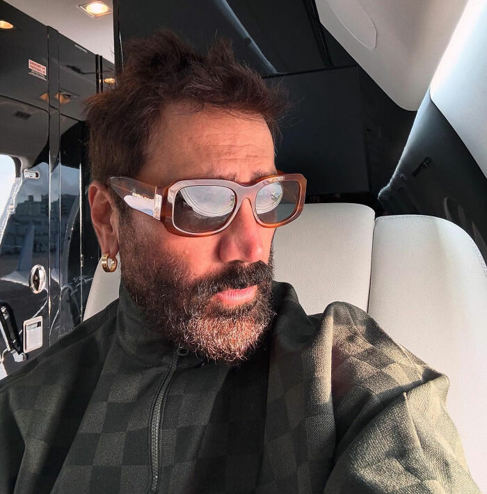 Man wearing sunglasses in a vehicle, possibly related to World Cup headliner