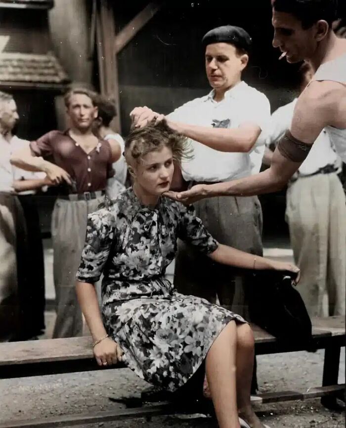 A colorized historical photo shows a woman getting her head shaved by a man, almost impossible to explain.