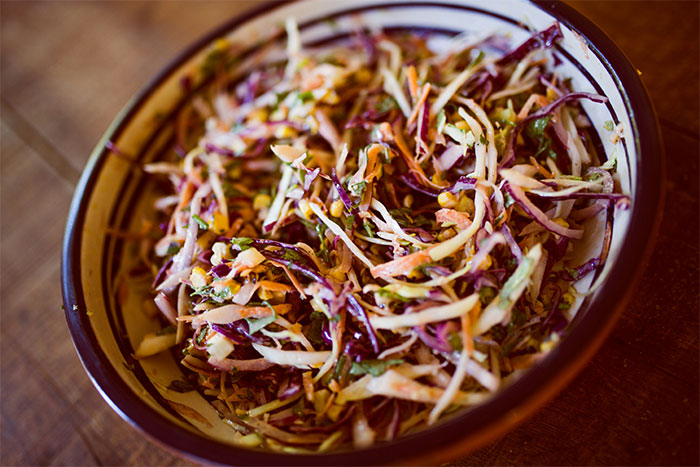 A close-up of a bowl of colorful coleslaw, a food issue for a kid.