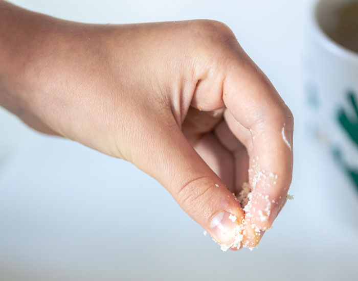 Close-up of hand holding and sprinkling medicine powder gently