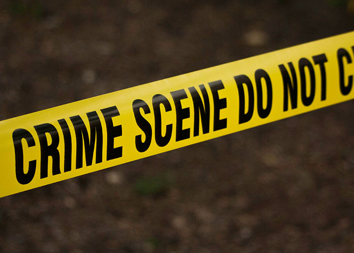 Yellow crime scene tape indicating a restricted area at a crime location