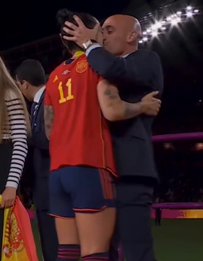 Coach kissing female football player during World Cup ceremony