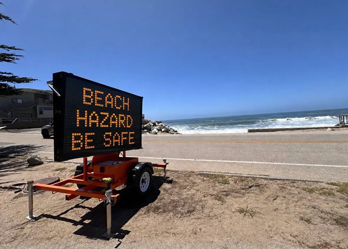 Beach hazard warning sign on California beach urging safety near the ocean Beach hazard warning sign on California beach urging safety near the ocean