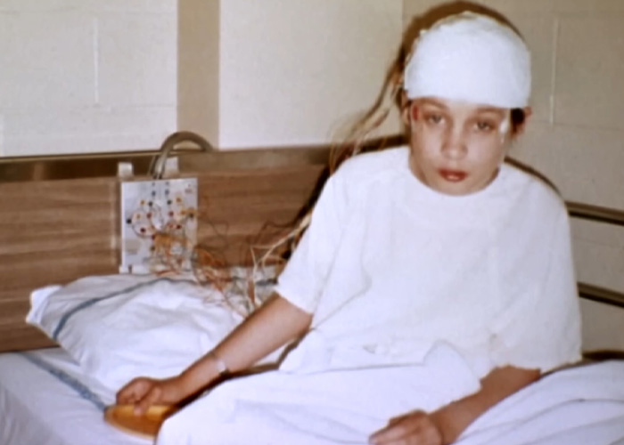 A girl abandoned by parents in a hospital bed with a bandaged head, showing a difficult start to life. A girl abandoned by parents in a hospital bed with a bandaged head, showing a difficult start to life.