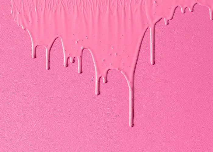Pink paint dripping down a wall, showcasing creative and unserious solutions to problems.