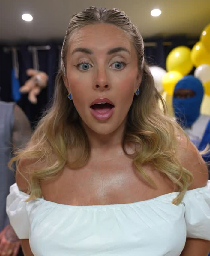 Bonnie Blue shows a surprised expression, with wide eyes and open mouth, amidst baby shower decorations.