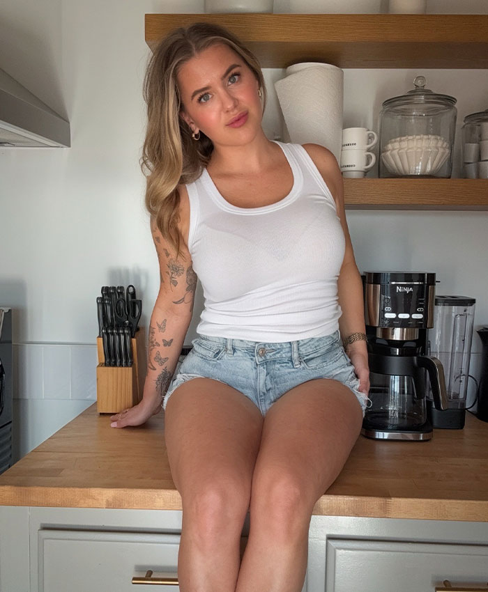 Woman in white tank top, involved in the Lily Phillips Backdoor Challenge, discusses her marriage problems.