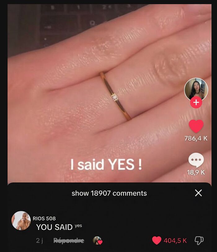A hand wearing a ring that says I said YES with a funny comment below.
