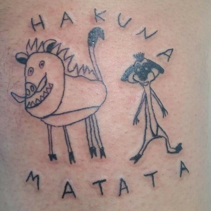 Hilarious tattoo fail depicting poorly drawn Pumbaa and Timon from The Lion King with Hakuna Matata.