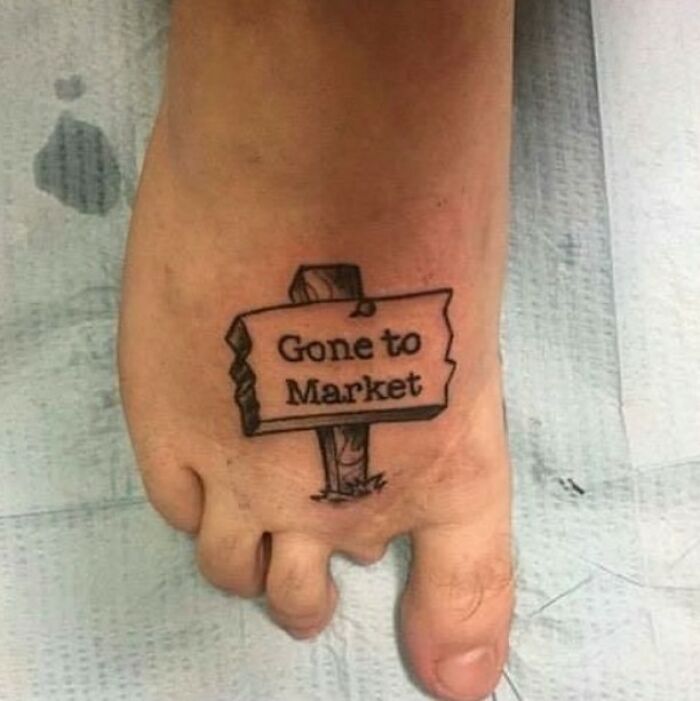Funny tattoo fail of a small sign on a foot that says Gone to Market, referencing the nursery rhyme.