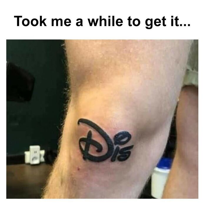 Hilarious tattoo fail with a Disney-style logo on a knee, resembling a misspelled word. 