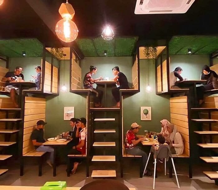 Innovative restaurant booth design with elevated and ground seating areas