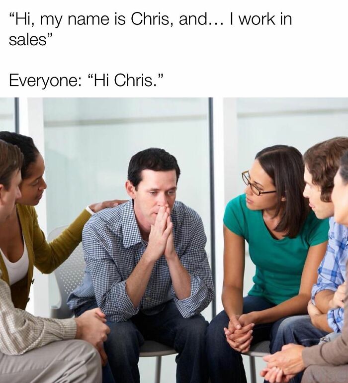 Man looking stressed while sharing that he works in sales with comforting colleagues