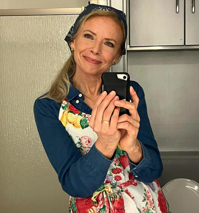 Woman in a floral apron and headscarf taking a selfie, relevant to the Hollywood voting scandal report. Woman in a floral apron and headscarf taking a selfie, relevant to the Hollywood voting scandal report.