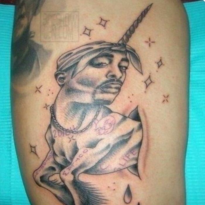 Hilarious tattoo fail meme featuring a black and white tattoo of Tupac Shakur with a unicorn horn.