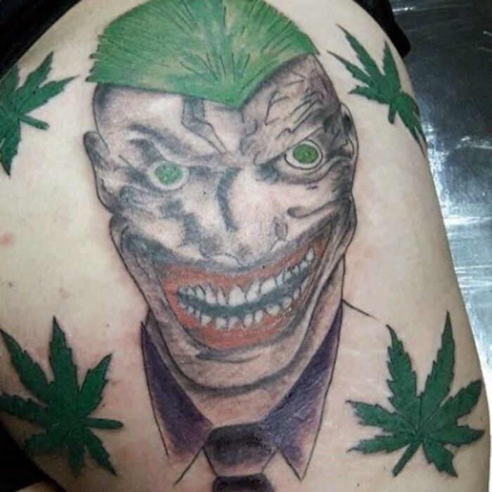 Hilarious tattoo meme showing the Joker with green cannabis leaf hair and surrounded by more cannabis leaves.