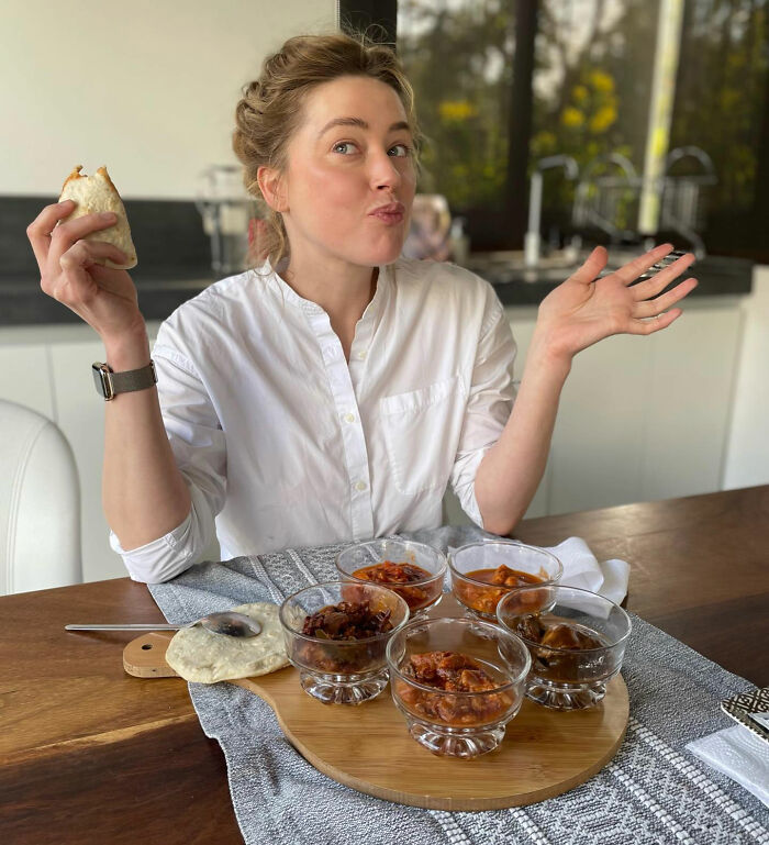 Amber Heard posing with food, showing her new life in a new country away from Hollywood. Amber Heard posing with food, showing her new life in a new country away from Hollywood.