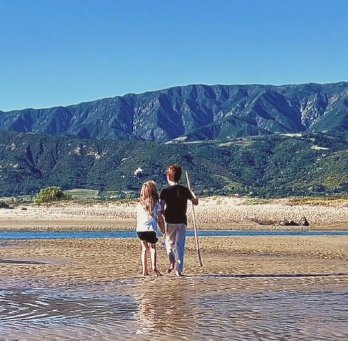 Meghan Markle's kids, Lilibet and Archie, walk on a beach with a stick, intensifying concern for them. Meghan Markle's kids, Lilibet and Archie, walk on a beach with a stick, intensifying concern for them.