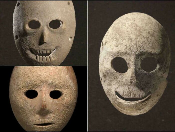 Collection of creepy ancient stone masks with hollow eyes and eerie smiles