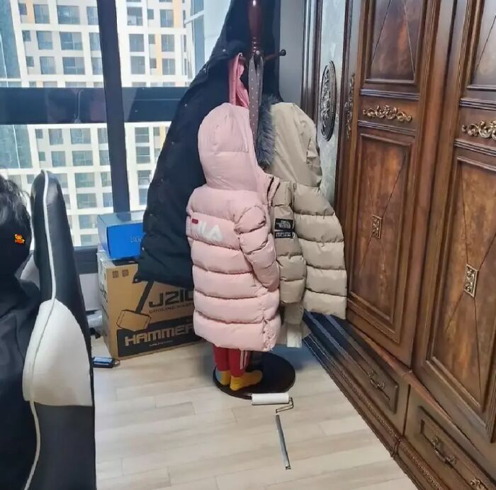 Extraordinary details with coats making a child look hidden in plain sight indoors