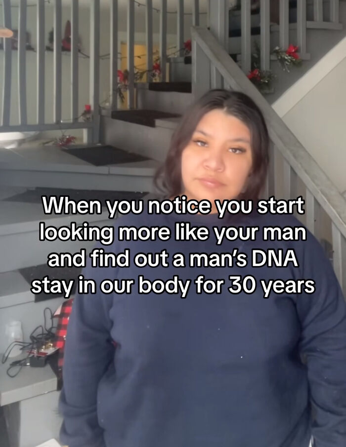Woman stands by staircase with text about man's DNA staying in body 30 years