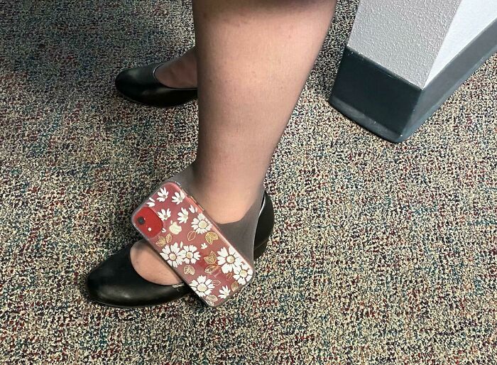 Woman's shoe stuck with phone on carpet, funny or cringe fail footwear mishap