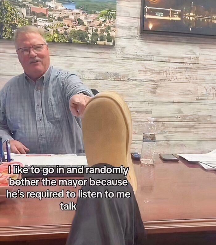 Embarrassing cringe photo of man with foot on table joking about mayor