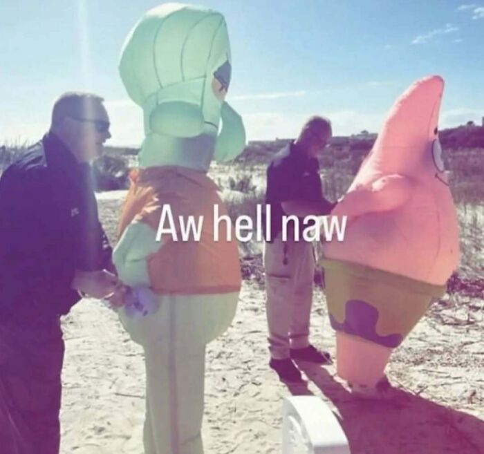 Weird random image of people with giant cartoon character costumes on a beach