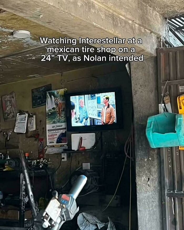 Image of a small TV in a tire shop showing a movie scene with humorous caption