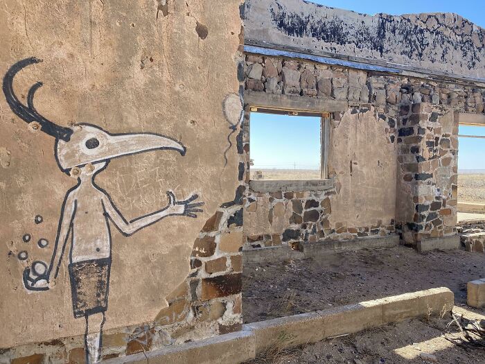 Graffiti art on crumbling stone walls in a forgotten urban exploration site