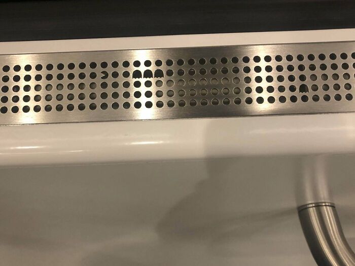 Innovative metal sink grate draining water with a clever design
