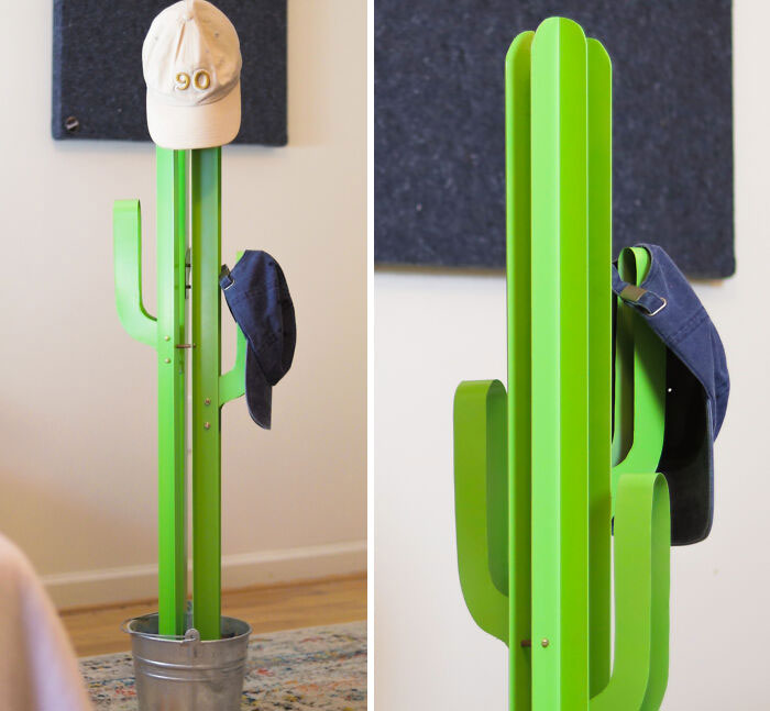 Green cactus-shaped coat rack holding hats indoors