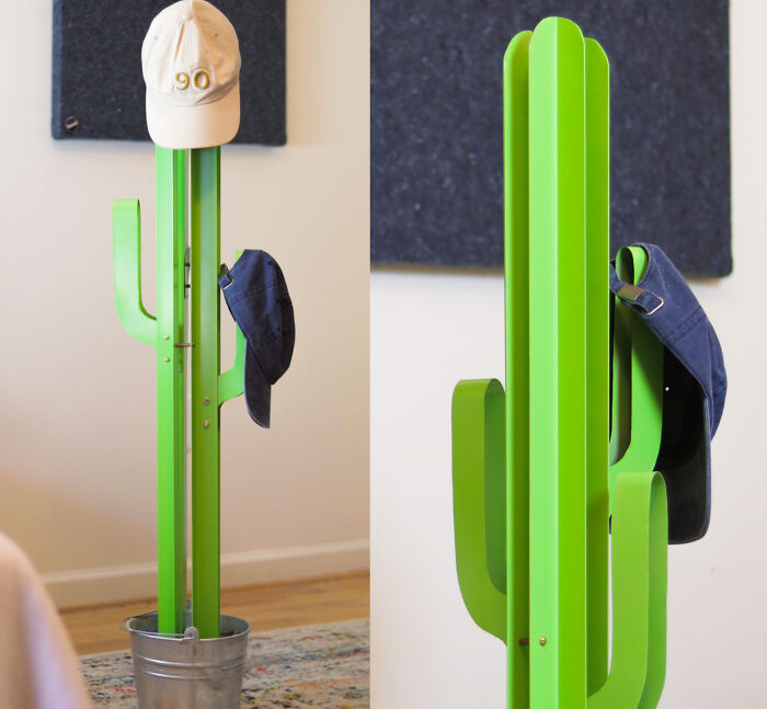 Green cactus-shaped coat rack holding hats indoors