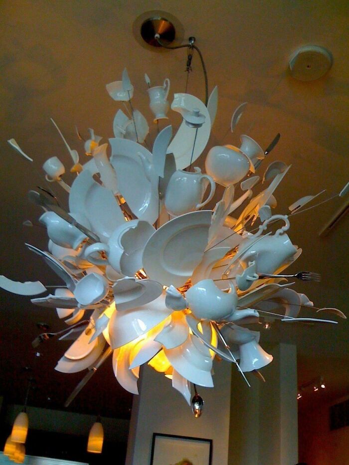 Artistic chandelier made from broken white ceramics and utensils